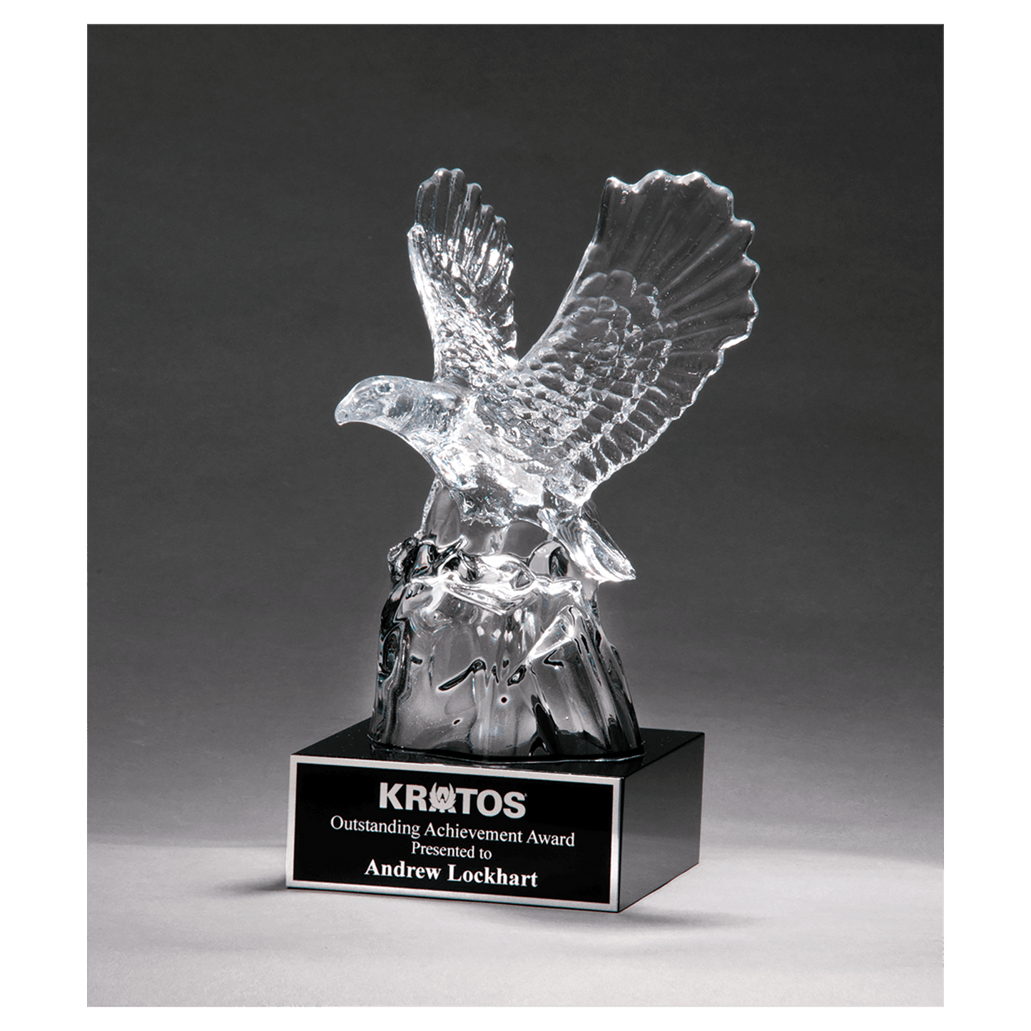 Carved crystal eagle award mounted on a black crystal base with a black engravable aluminum plate, 9.5 inches tall