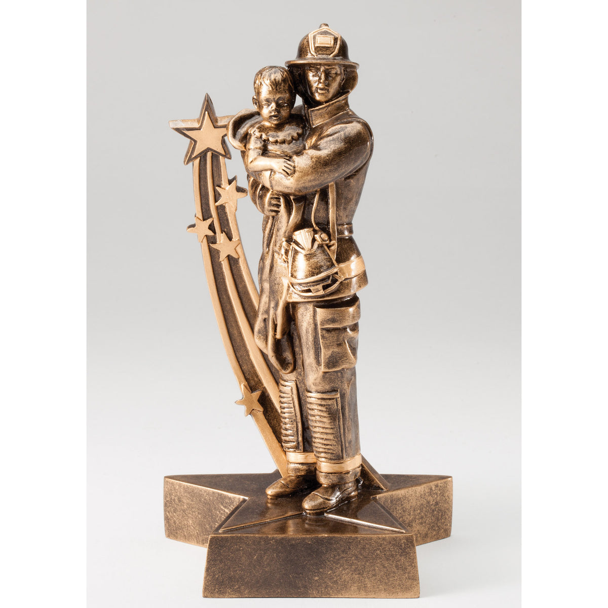 Antique gold resin trophy of a firefighter carrying a child beside a shooting star