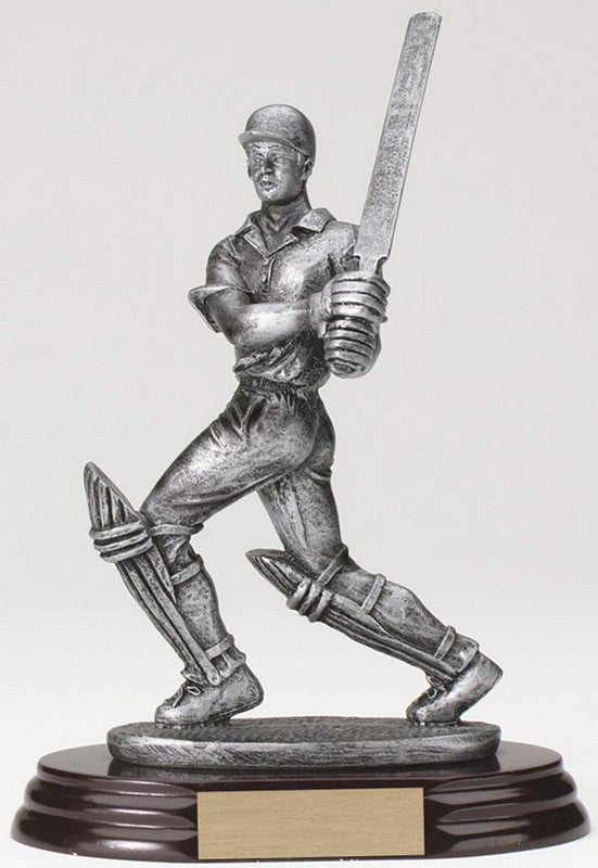 Pewter finish cricket batsman in follow-through resin trophy on black base, 7 inches