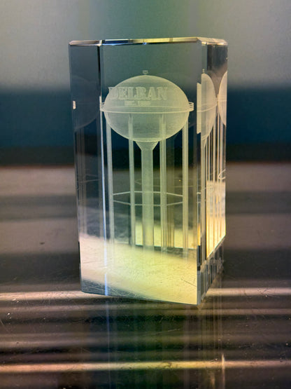 Clear crystal block with engraved water tower design on a reflective surface