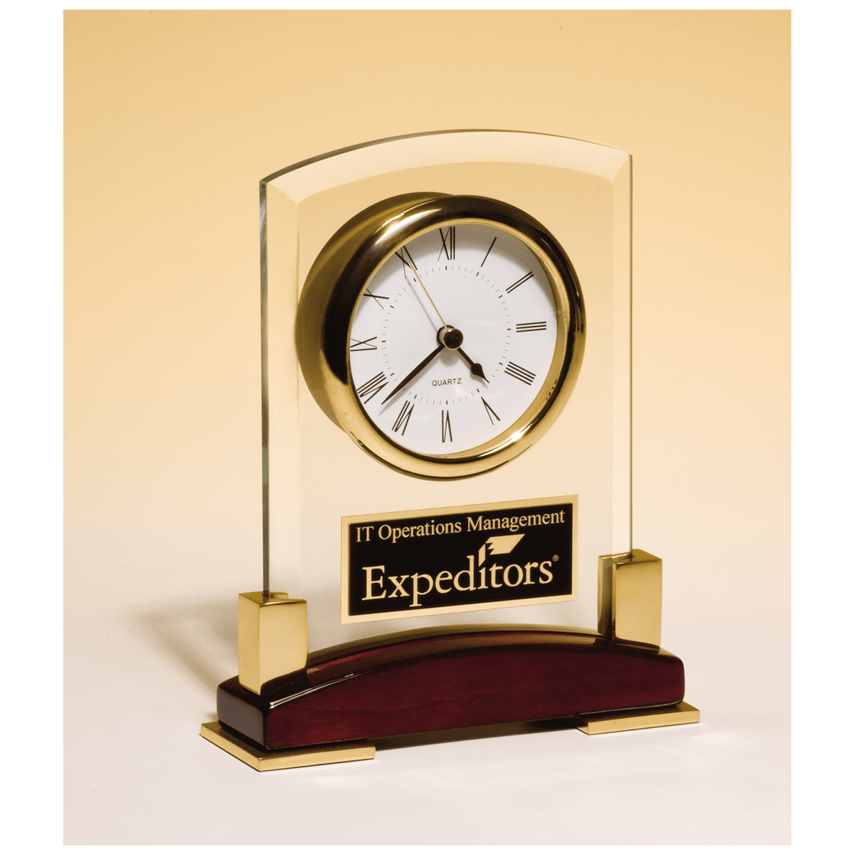 Beveled glass desk clock with rosewood piano finish base and gold accents