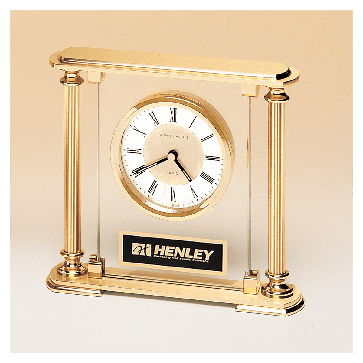 Glass upright clock with feet and top, metal goldtone columns, and diamond spun dial
