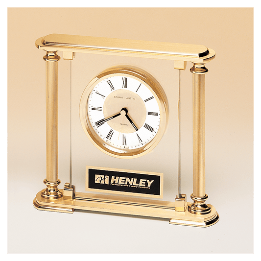 Glass upright clock with feet and top, metal goldtone columns, and diamond spun dial