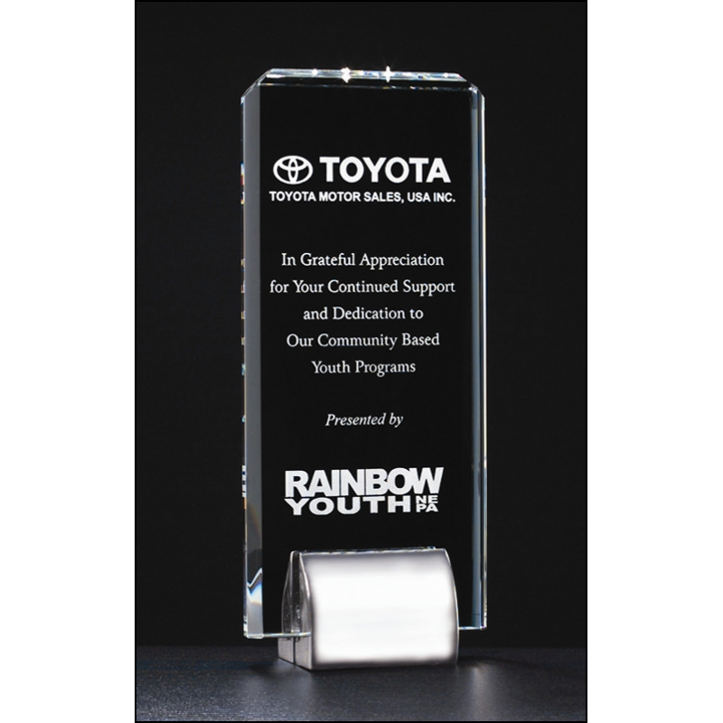 Clear glass award with Toyota and Rainbow Youth logos on a black background