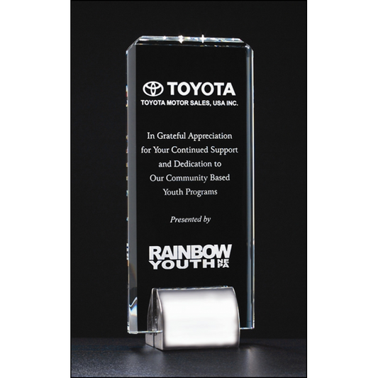 Clear glass award with Toyota and Rainbow Youth logos on a black background