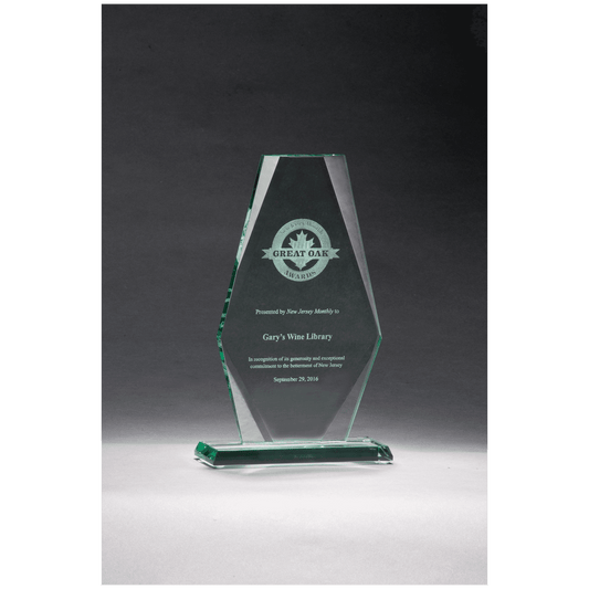 Glass award with engraved text on a dark background
