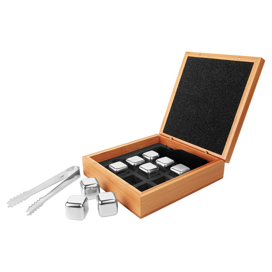 Set of metal whiskey cooling stones and tongs in a wooden box on a white background