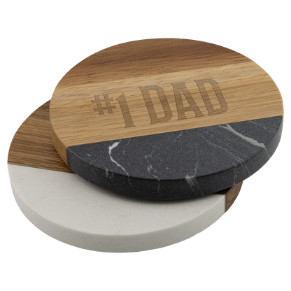 Stack of engraved round acacia and marble coasters