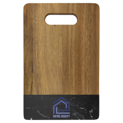 Engraved acacia and black marble cutting board styled in a kitchen