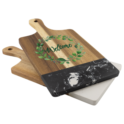 Stacked acacia and marble cutting boards styled on a counter