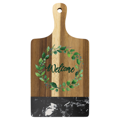 Engraved acacia and black marble paddle board styled with food