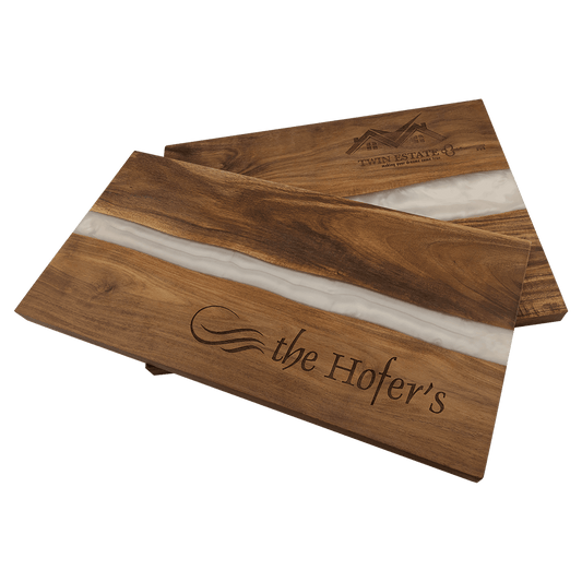 Two wooden cutting boards with 'the Hofer's' branding on a transparent background