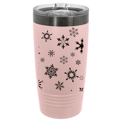 Pink tumbler with black snowflake patterns on a white background