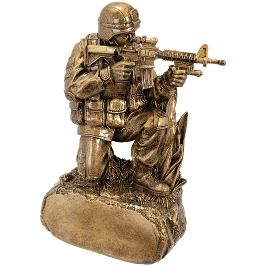 Antique gold military resin award, kneeling soldier on grass, 9.25 inches