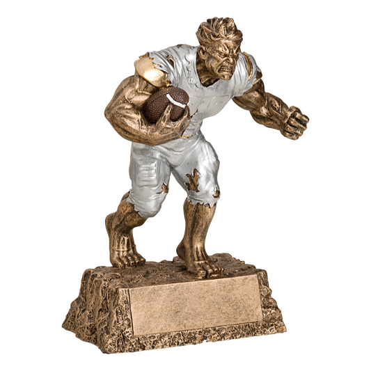 Hand-painted gold and silver resin trophy of a snarling muscular monster in a torn football uniform carrying a football, on a textured base with a blank engraving plate