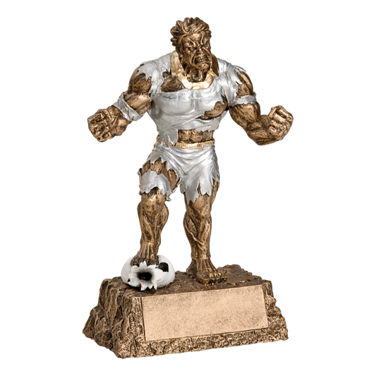 Hand-painted gold and silver resin trophy of a muscular monster in a torn soccer kit with a soccer ball, on a textured base with a blank engraving plate