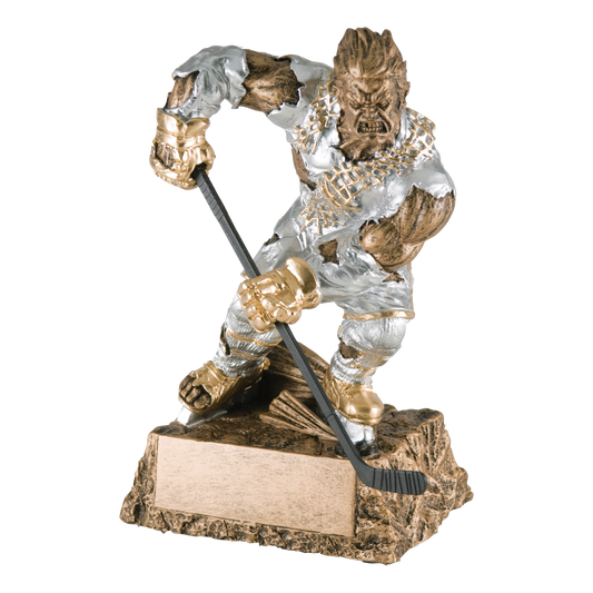 Hand-painted gold and silver resin trophy of a muscular monster in a torn hockey jersey holding a stick, on a textured base with a blank engraving plate
