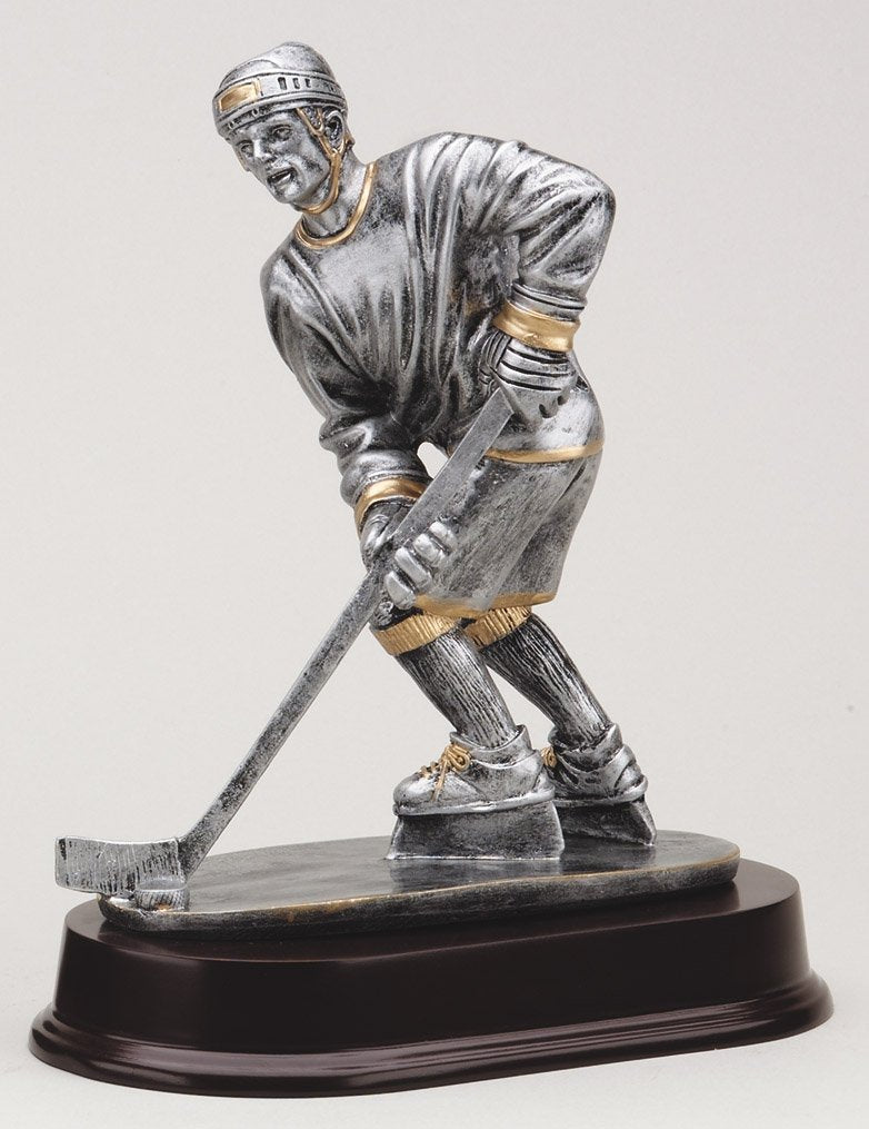 Pewter ice hockey player trophy with gold trim on rosewood-finish base
