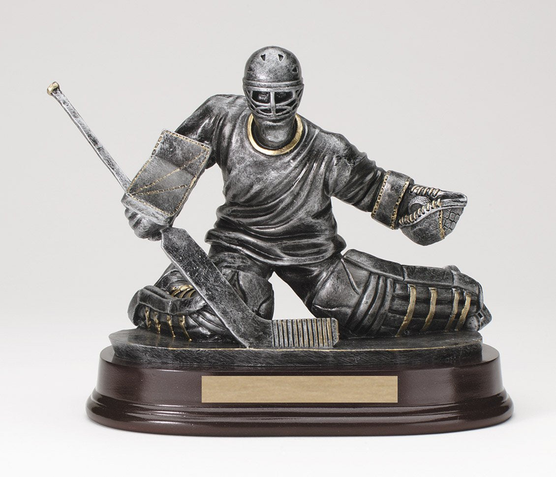 Pewter hockey goalie trophy with gold trim in butterfly save