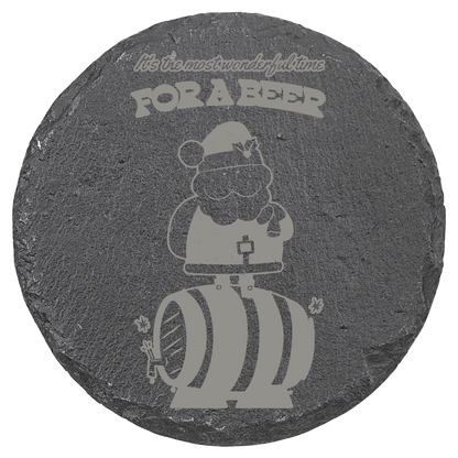 Round slate coaster with engraved design of a Santa on a barrel and text 'For a Beer'.