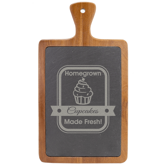 Wooden cutting board with slate insert displaying 'Homegrown Cupcakes Made Fresh!' text on a clear background