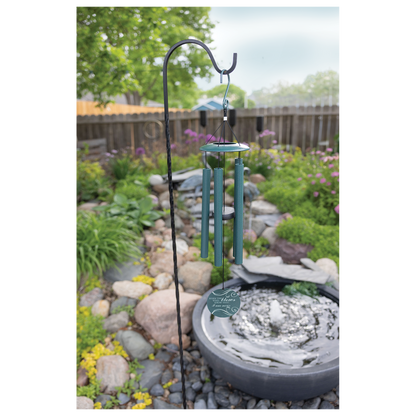 Engraved dark peacock green wind chime hanging outdoors