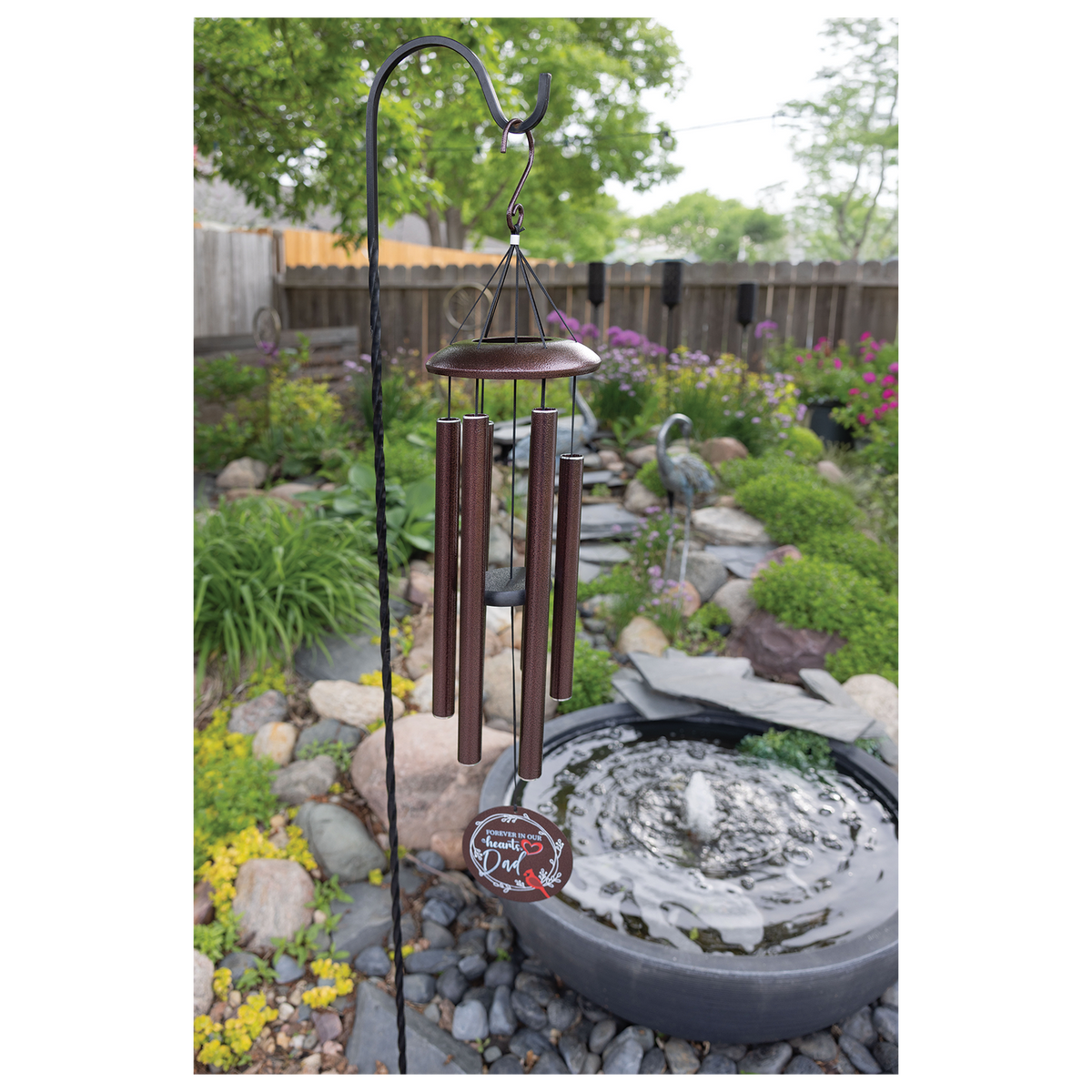 Engraved 36 inch copper memorial wind chime in a garden