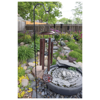 Engraved 36 inch copper memorial wind chime in a garden