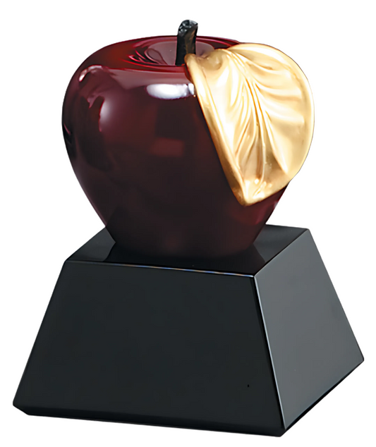 red apple on black base with leaf