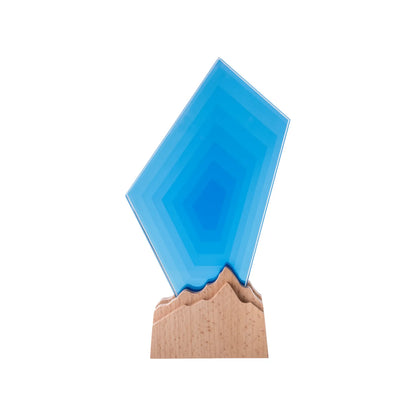 Blue faceted geometric crystal award on a natural beechwood mountain-peak base, front view
