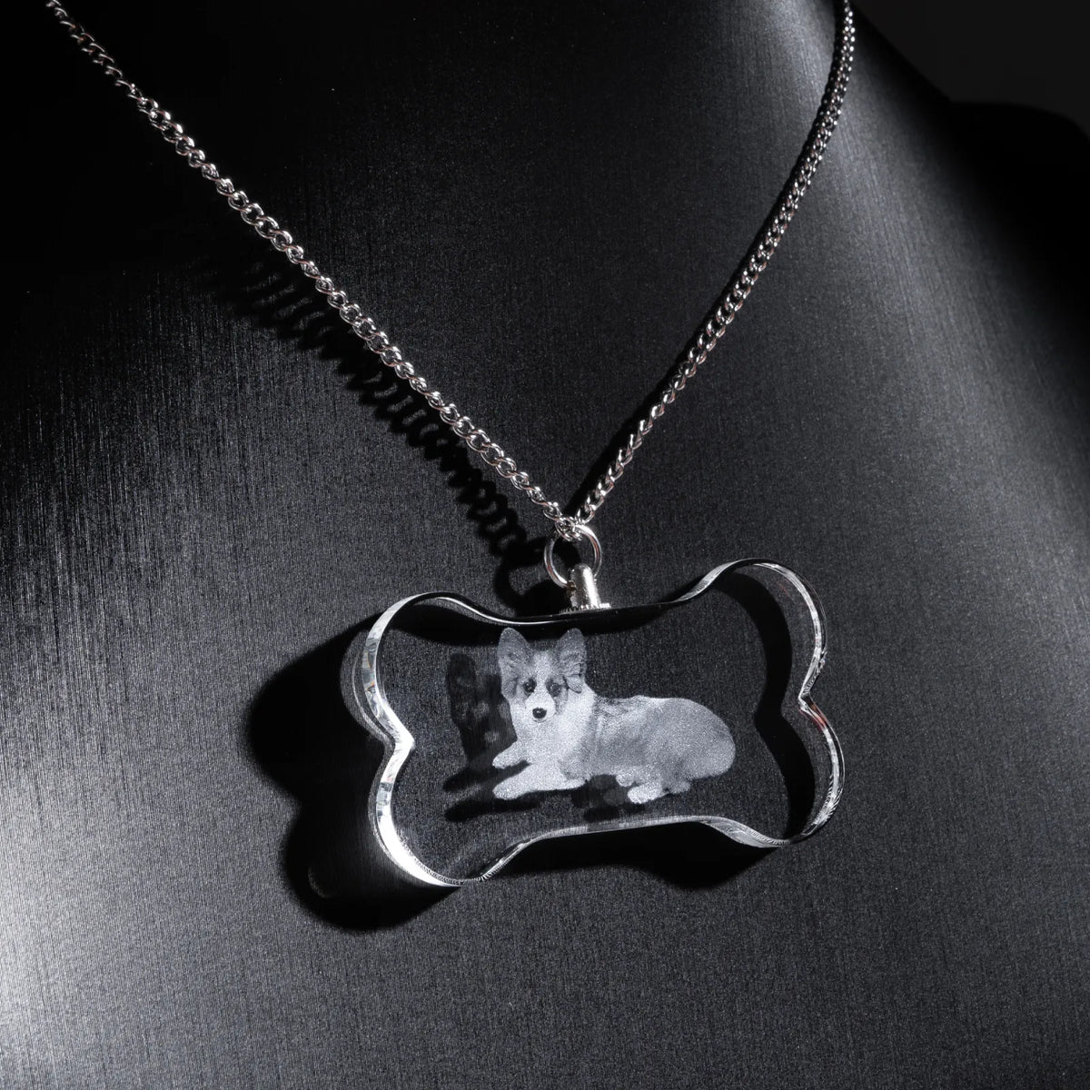 Clear bone-shaped crystal dog memorial necklace, close-up