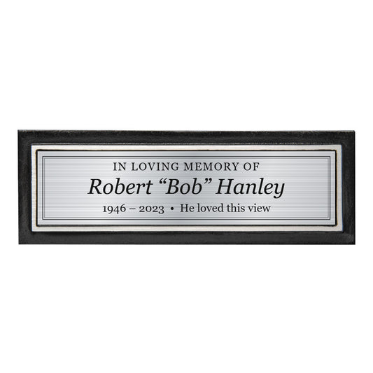 Black and silver cast aluminum memorial bench plaque with a custom engraved brushed silver plate