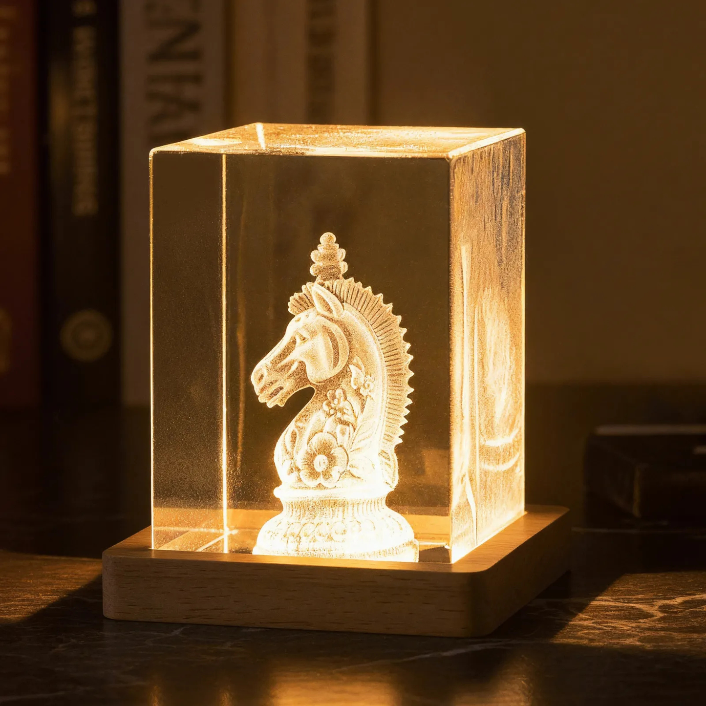 Clear glass block with 3D laser engraving of a chess piece on a wooden base.