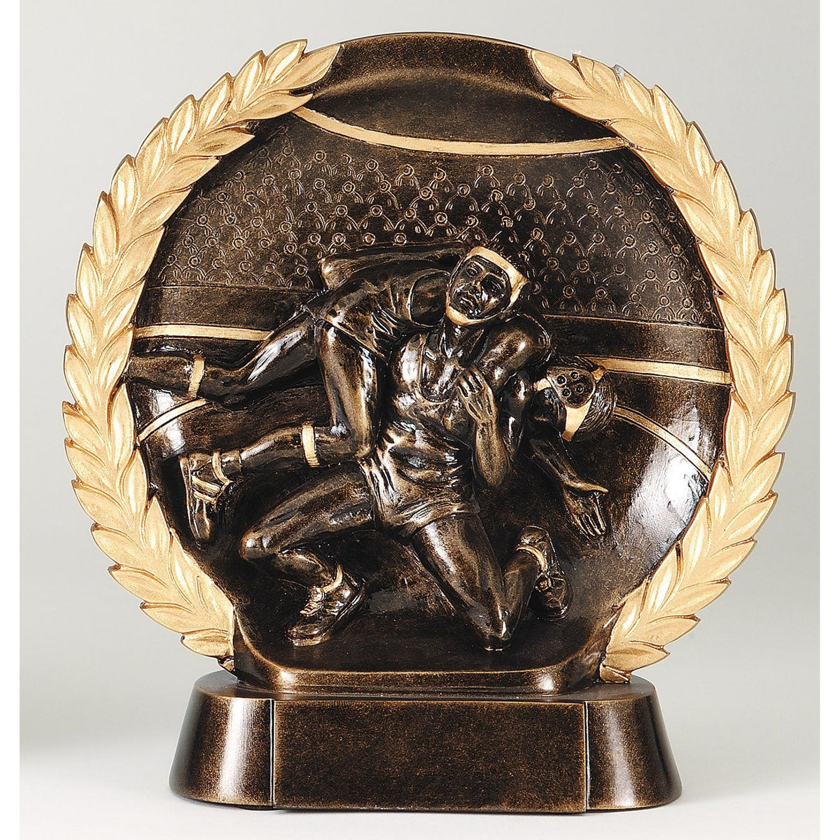 High relief wrestling plate award with sculpted wrestlers in antique bronze framed by a gold laurel wreath