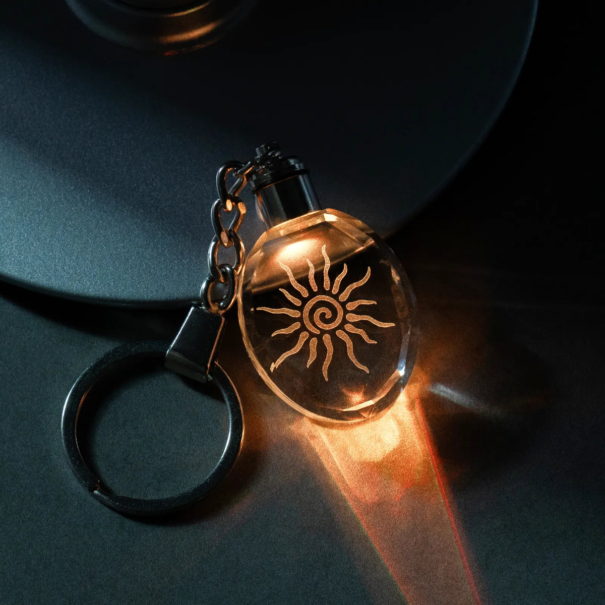 Personalized oval crystal keychain engraved with a photo, lit in multicolor LED