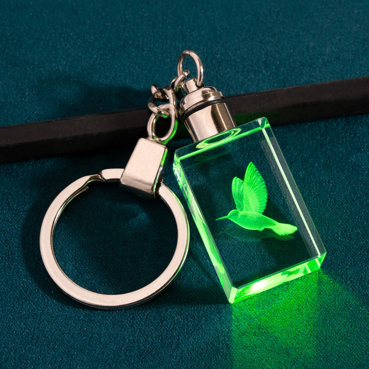 Personalized engraved crystal keychain glowing in multicolor LED, detail view