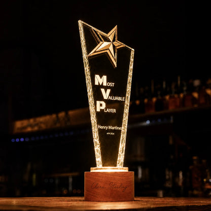 Personalized star crystal award engraved with an award title on a walnut base
