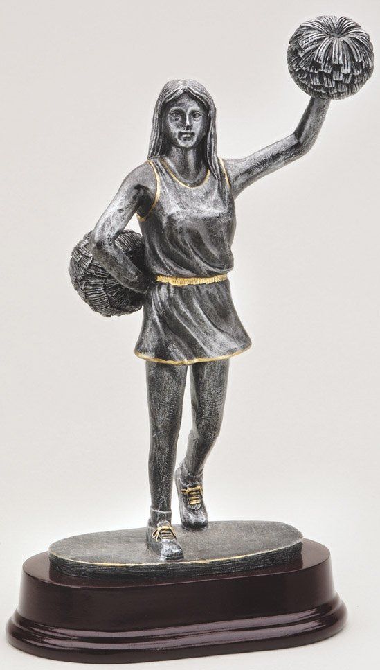 Cheerleader statue trophy in pewter finish with gold trim on wood-tone oval base